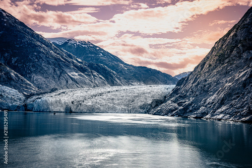 A Glacier in an Alaskan Fjord with Dramatic Mountain Landscape