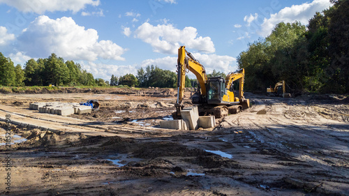 Bild auf Leinwand Yellow Excavators Digging Artificial Lake Site for Recreation Area Development