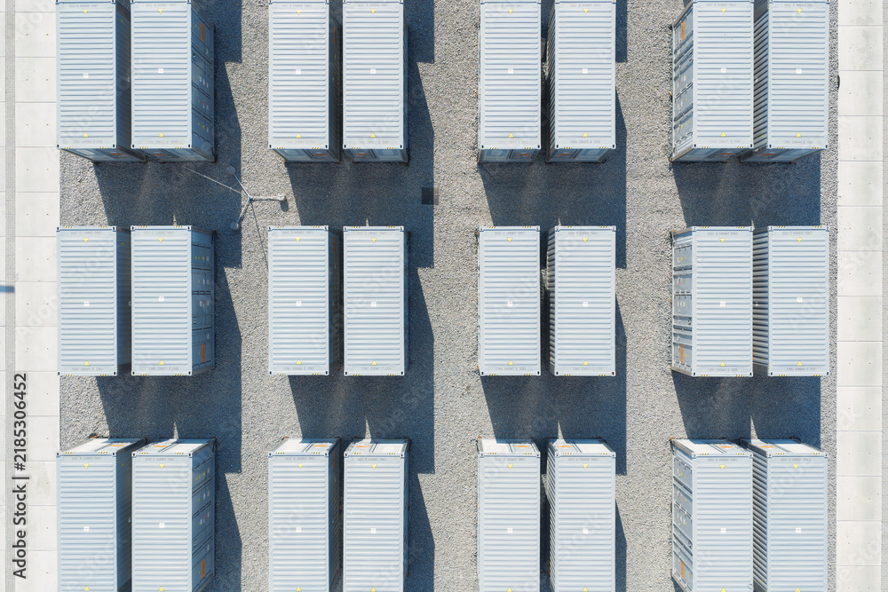 Obraz premium Aerial view of battery energy storage system facility for renewable power plant. Industrial lithium batteries used for clean electricity grid management.