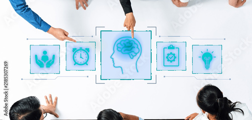 Aerial view of a collaborative brainstorming session with diverse individuals discussing innovative ideas, utilizing digital icons for creativity and problem-solving approaches. Nascent