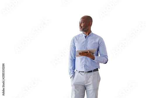 African american businessman holding tablet and looking away, standing confidently, planning and leading future success on transparent background