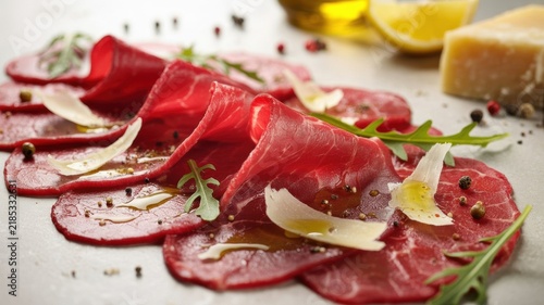 A national dish of Italian cuisine. 
Carpaccio is an Italian dish made from ultra‑thin slices of raw beef, traditionally served with Parmesan, arugula, and an olive oil and lemon dressing.