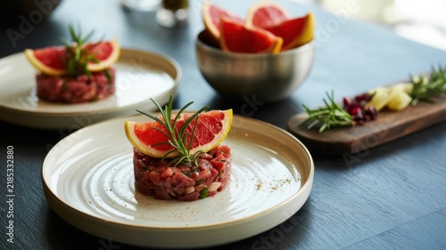 Beef tartare is a classic French cuisine dish consisting of finely chopped raw meat seasoned with spices and served raw. 