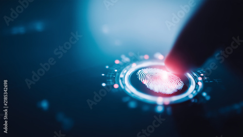 A fingertip presses a fingerprint scanner to represent biometric authentication identity verification and secure digital access.
