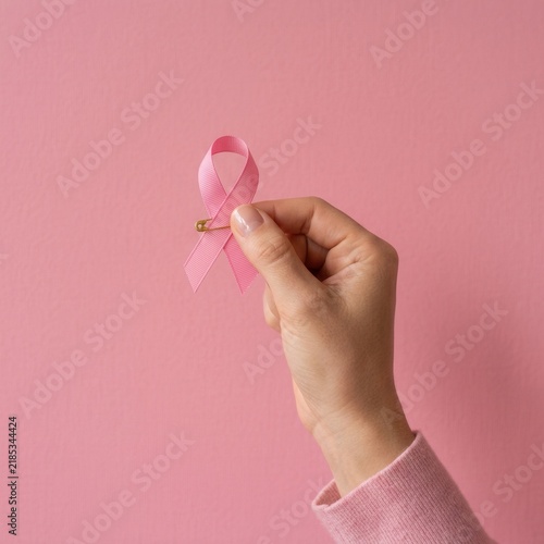 Symbol of Hope A Hand Holds a Pink Ribbon For Breast Cancer Awareness