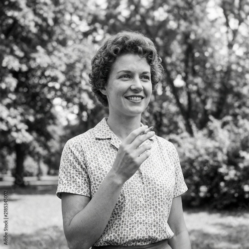 Vintage Portrait Of A Woman Enjoying A Cigarette Outdoors