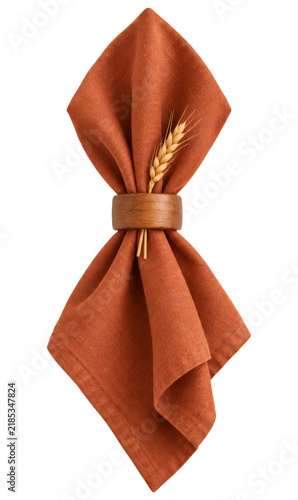 Orange linen napkin with wooden napkin ring and wheat ear on transparent background. Rustic table setting decoration for thanksgiving dinner and autumn holiday table decor concept.