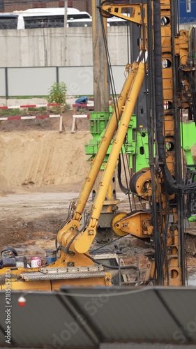 Heavy drilling equipment operating at a construction site for foundation preparation, showing industrial machinery, ground engineering and infrastructure development processes