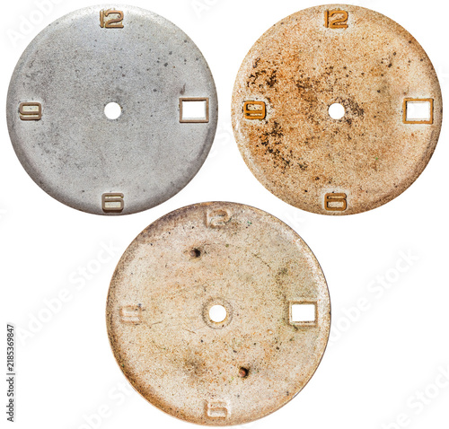 Isolated photo of steel and brass vintage worn clock or watch face on white background.