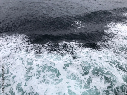 Obraz na płótnie Large Ocean Waves Viewed From Cruise Ship Deck on Sunny Day, Teal Water and Whit