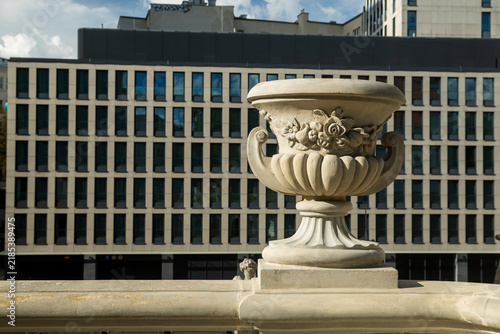 Decorative sandstone vase on the terrace balustrade of Ostrogski Palace (Zamek Ostrogskich) in Warsaw, Poland. Historic Baroque architectural detail.