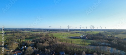 Картината върху платно Panoramic aerial view of a wind farm with numerous wind turbines standing in gre