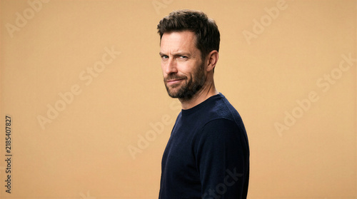 Man with a sarcastic smirk and side-eye expression looking at the camera