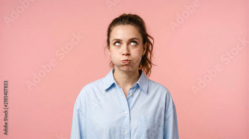 Woman with puffed cheeks and rolled eyes showing annoyance or disbelief