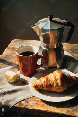 A cup of coffee and a fresh baked croissant