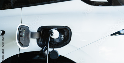White electric car charging with copy space, Technology electric vehicle concept