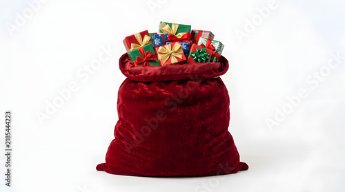 Sack overflows with brightly wrapped presents against a clean transparent background.