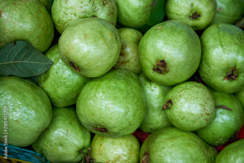 Fotografie Close-up of green guavas stacked on market stall