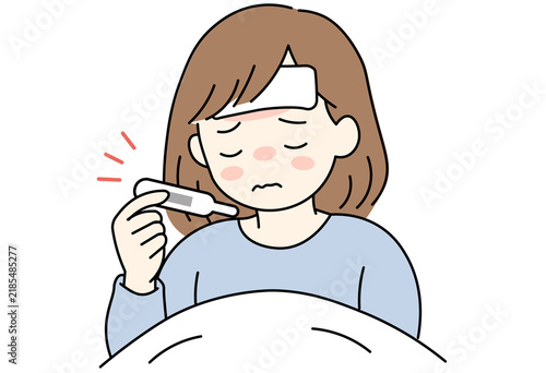woman in bed checking a thermometer with a high fever of 38.5 degrees.