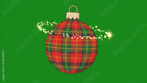 Rotating red plaid Christmas bauble ornament with glowing magic sparkle trail on green screen. Perfect for holiday video editing projects.