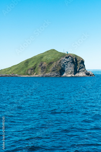 Cape Peshi Observatory and steep green cliffs over the blue Sea of Japan, Rishiri Island