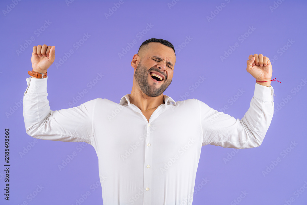 Fototapeta premium Young adult man expressing intense emotion celebrating victory