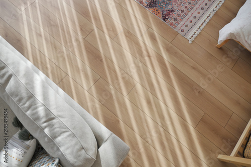 Sunlight warms wooden floor in cozy room