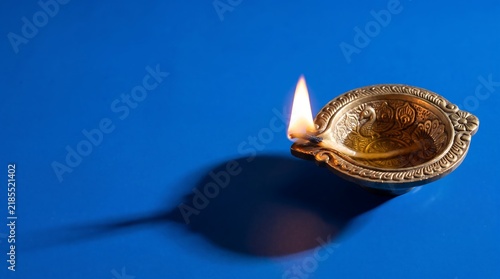A beautifully lit diya lamp embodies the spirit of diwali symbolizing light overcoming darkness and hope prevailing over