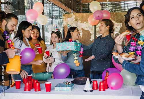 Photography portrait of latin friends celebrating in birthday party at terrace outdoors in Mexico Latin America
