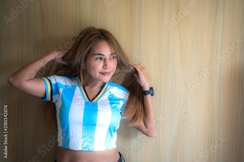 A woman is wearing a blue and white football team jersey, only the upper half of her body is visible.