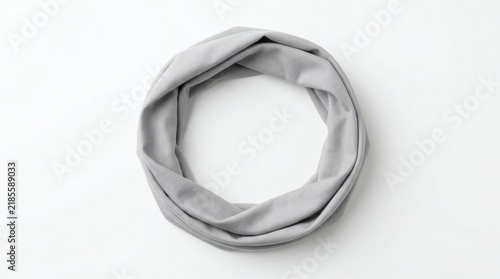 Grey loop infinity scarf, modern winter neckwear, simple fashion accessory, soft fabric textile detail, minimalist clothing style, elegant accessory. White background.