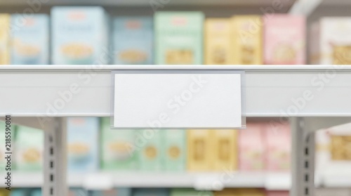 White blank price tag on supermarket metal shelf, medicine packaging background, blurred pharmacy aisle interior, realistic empty label copy space for retail product display concept