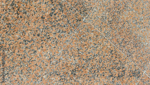 close-up, top-down view of polished granite tiles, characterized by a dense, mottled pattern of reddish-orange, black, grey, and white mineral grains