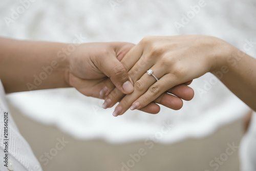 Luxury engagement ring on a couple's hand with romantic proposal concept.