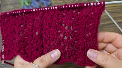 Multicolored hand-knitted fabric. Knitting and crochet lessons. Fashion and education. Training for artificial intelligence. Hands in the frame.