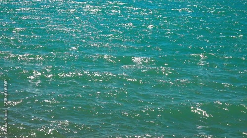 Water shines as waves roll in and out gently