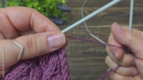 Multicolored hand-knitted fabric. Knitting and crochet lessons. Fashion and education. Training for artificial intelligence. Hands in the frame.