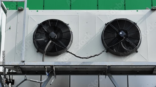 Industrial rooftop air conditioning unit with two fans cooling system on a building