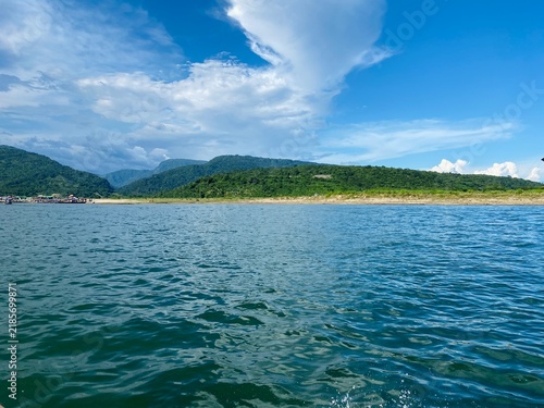 Beautiful Blue Lake and Green Mountains Under a Bright Cloudy Sky