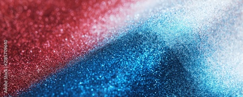 Close-up of red, white, and blue glitter particles creating a sparkling, textured surface with a smooth gradient effect.
