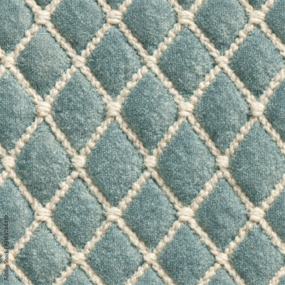 Obraz premium Seamless pattern quilted teal velvet fabric creating a diamond pattern, soft textile with woven cream thread details, elegant upholstery texture background