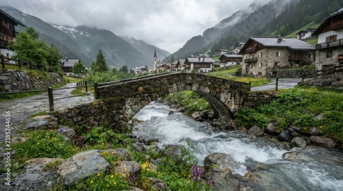 Old stone bridge over a mountain stream in a scenic alpine village.