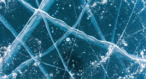 High resolution top down photograph of natural teal mountain lake ice with fractures and skate scratches
