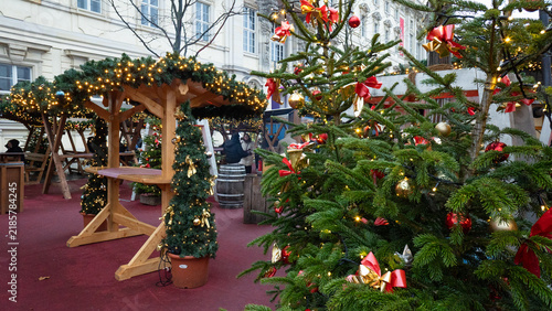 Christmas market stalls and decorated fir trees creating festive atmosphere