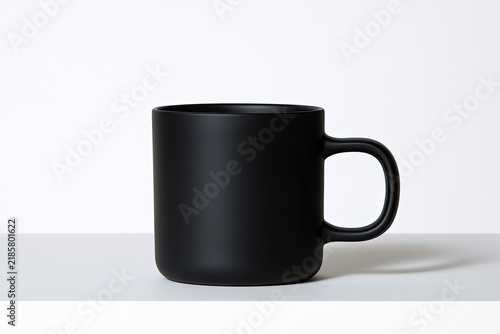 Minimalist matte black mug on a white surface