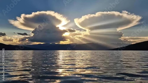Dramatic Sun Rays Over Lake and Mountain Landscape