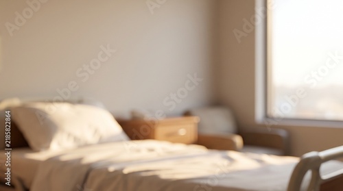 Blurred hospital room interior with empty patient bed and window light