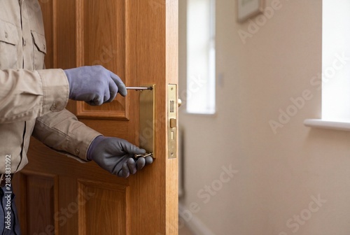 Craftsman Securing Brass Door Handle Components During Residential Home Improvement