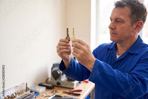 Locksmith Matching Metal Key Blank With Original Pattern at Workbench