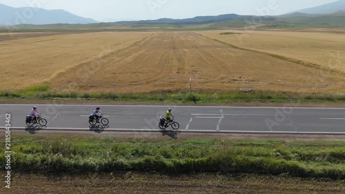 05.08.2026 Family cycling together on city road in Armenia, West Asia. Cyclists riding on road in Armenia. Father mother and daughter cycling together on city road. Concept of training outdoors. Healt